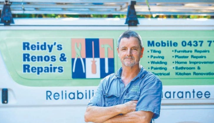 Andrew Reid standing with arms crossed infront of Reidy's Renos and Repairs branded white van